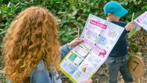A child looking at a Easter Trail map
